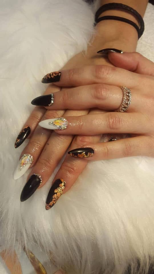 Black almond nails with gold foil and glitter accent nails